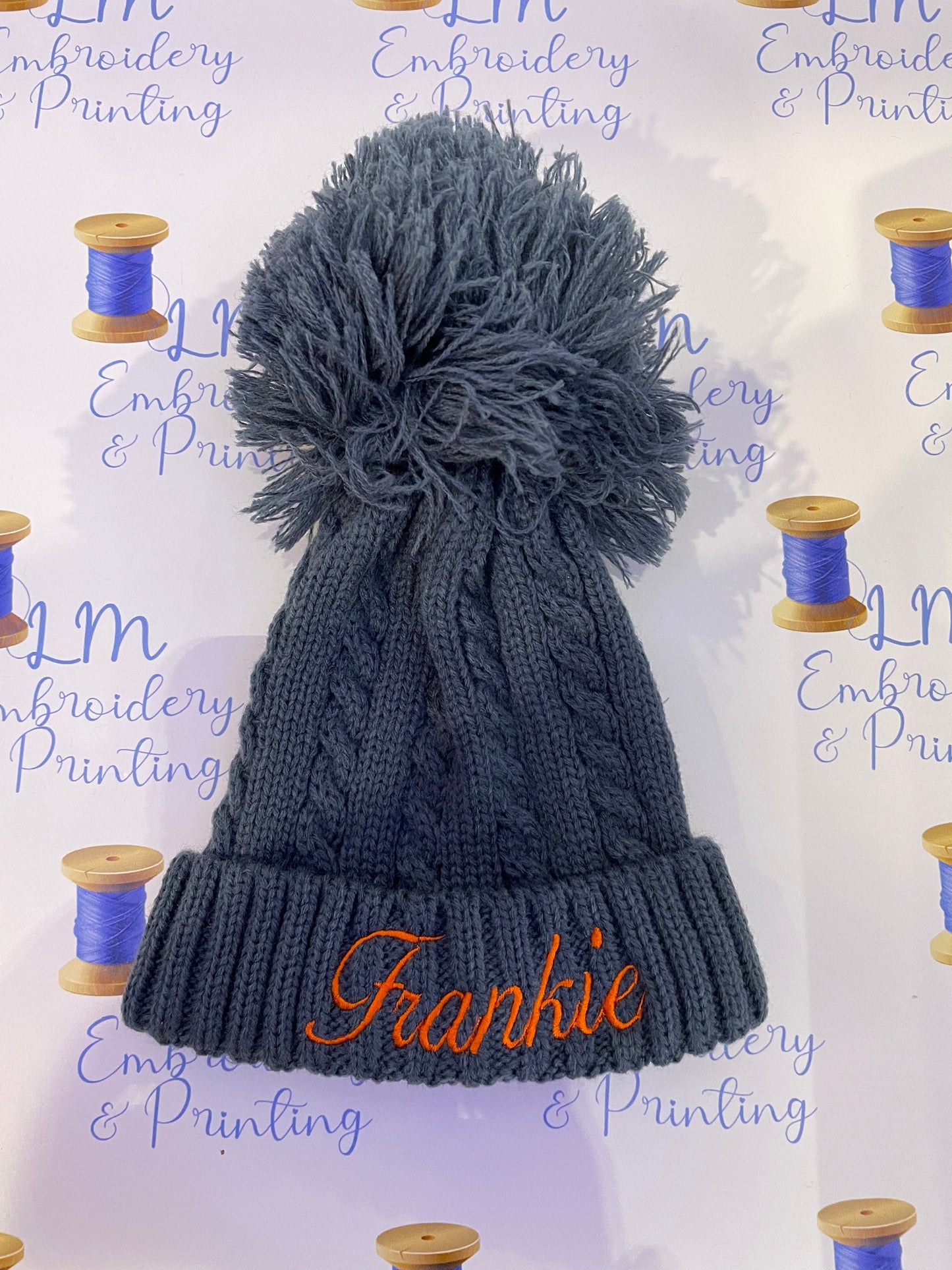 Navy pom pom knitted beanie