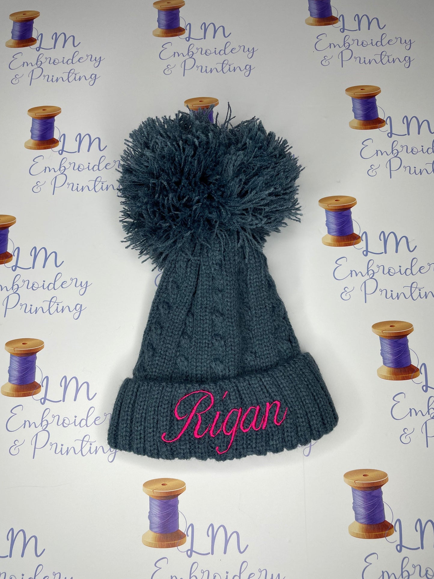 Navy pom pom knitted beanie