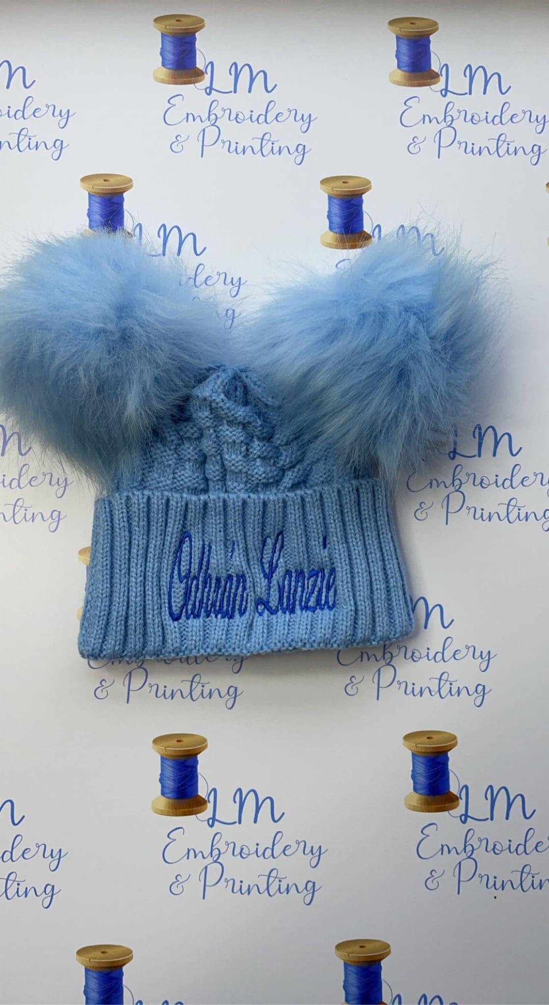Blue double pom pom knitted beanie